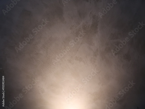 Light shines on the dark gray wall. Interior concept.
