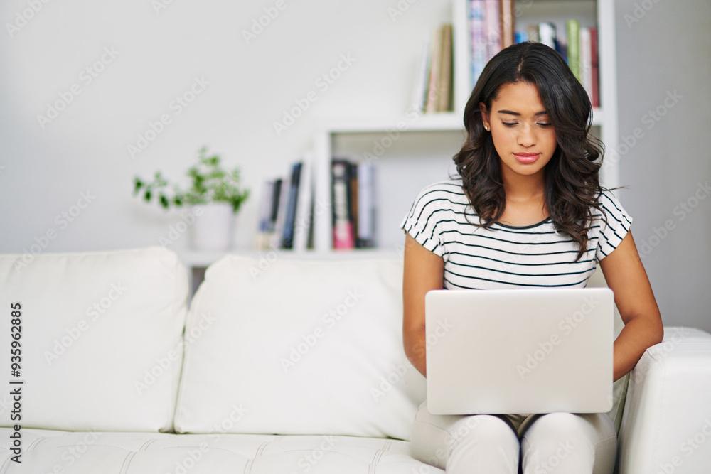 Laptop, sofa and woman in home with research for creative freelance project with public relations career. Typing, technology and female brand manager reading report for client feedback in apartment.