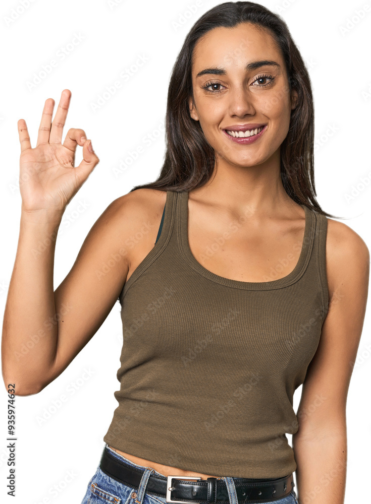Hispanic young woman cheerful and confident showing ok gesture. Hispanic young woman cheerful and confident showing ok gesture.