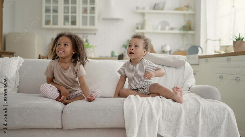 Two happy black kids playing with balloons in apartment, joyful little children. Happiness and joy, emotional African American girlie hitting balloon up and smiling, toddlers siblings, happy childhood Two happy black kids playing with balloons in apartment, joyful little children. Happiness and joy, emotional African American girlie hitting balloon up and smiling, toddlers siblings, happy childhood