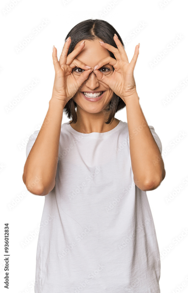 Young Caucasian woman with short hair showing okay sign over eyes Young Caucasian woman with short hair showing okay sign over eyes