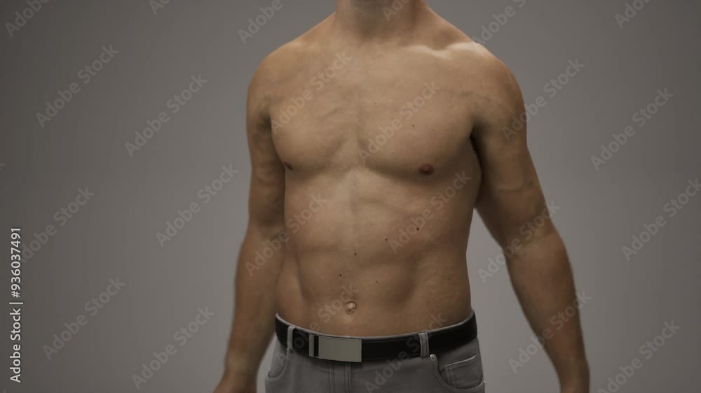 A man without a shirt confidently poses for a picture, showcasing his ...