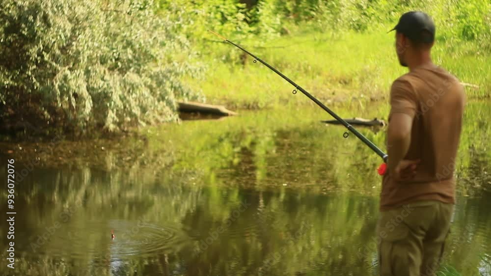 angler to catch fish on river in summer. rear view angler to catch fish on river in summer. rear view