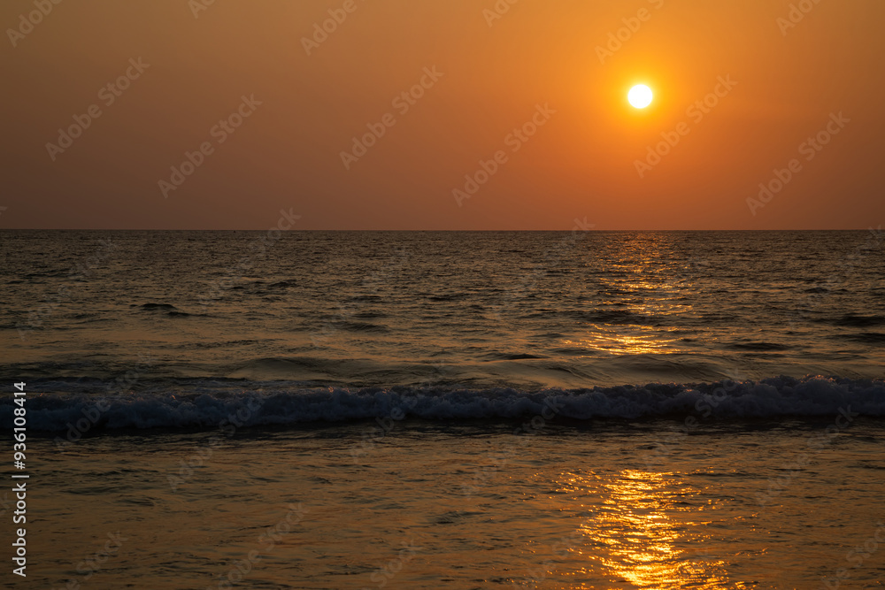 Beautiful sunset in the desert. Desert near the sea. Colorful sky. Warm summer evening.