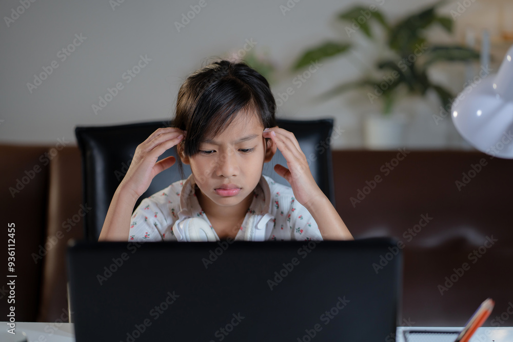 Tired kid student during the online education in the home. Unhappy girl student having problem with concentrate while attention online class. Tired kid student during the online education in the home. Unhappy girl student having problem with concentrate while attention online class.