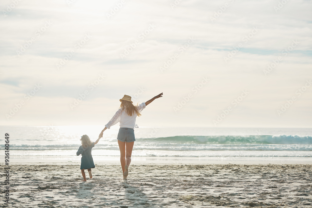 Mom, girl and back on beach with freedom on summer vacation, journey and seaside adventure for memories. Mother, female child and holding hands by ocean on holiday, together and bonding with love. Mom, girl and back on beach with freedom on summer vacation, journey and seaside adventure for memories. Mother, female child and holding hands by ocean on holiday, together and bonding with love.