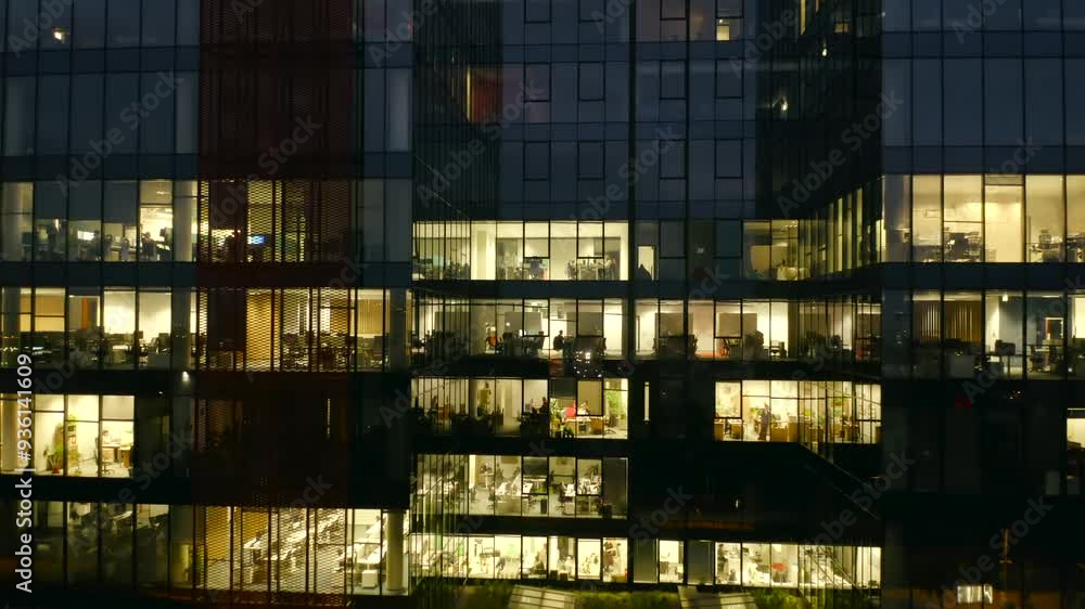 The drone provides a wide-angle view of a glass skyscraper, its windows aglow with the lights of office workers burning the midnight oil, reflecting the high-pressure atmosphere of urban business. The drone provides a wide-angle view of a glass skyscraper, its windows aglow with the lights of office workers burning the midnight oil, reflecting the high-pressure atmosphere of urban business.