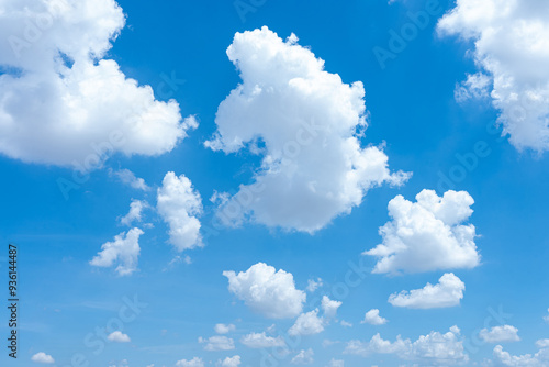 Fototapeta Naklejka Na Ścianę i Meble -  A bright blue sky with fluffy white clouds on a sunny day