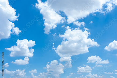 Bright blue sky with fluffy white clouds on a sunny day