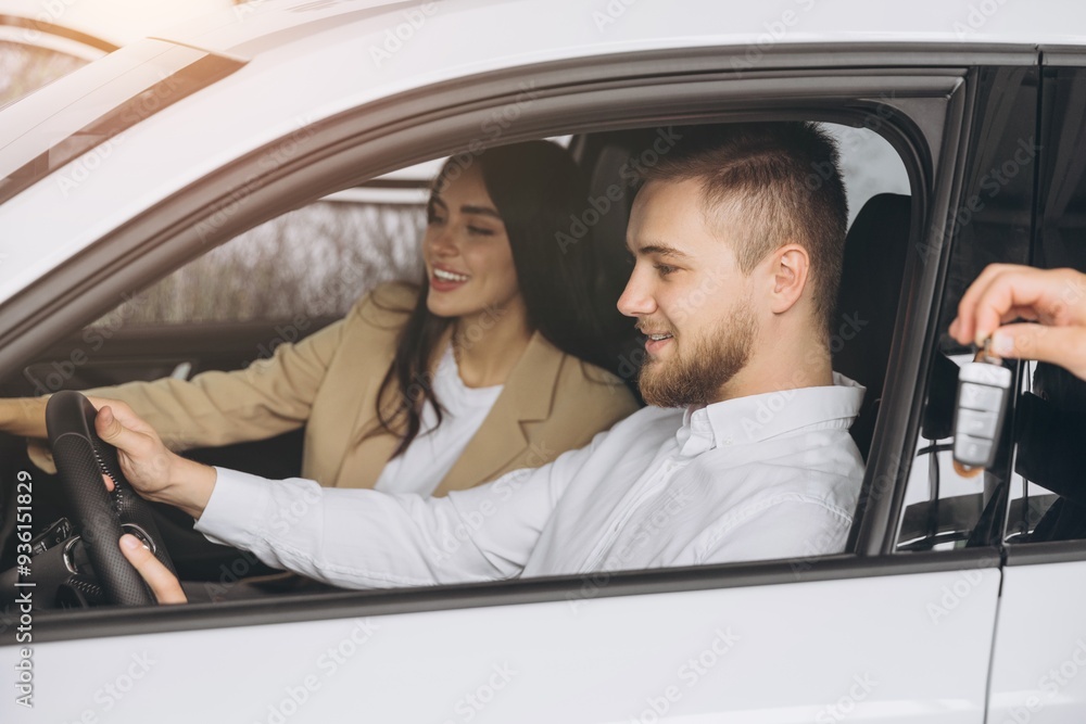 Happy couple buying car in huge showroom, taking automobile key from young handsome salesman while sitting inside auto. Cheerful arab man and woman purchasing beautiful vehicle, closeup Happy couple buying car in huge showroom, taking automobile key from young handsome salesman while sitting inside auto. Cheerful arab man and woman purchasing beautiful vehicle, closeup
