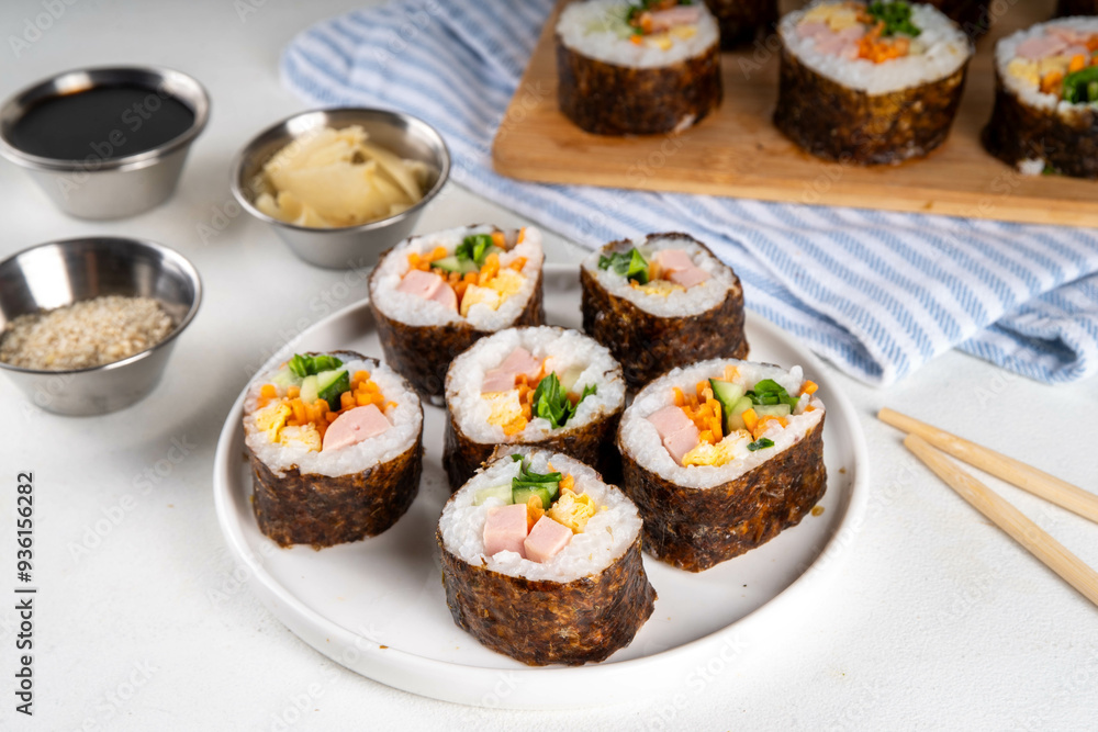 Gimbap or kimbap, korean rolls, traditional dish. Homemade kimbap roll with ham, vegetables and lettuce Gimbap or kimbap, korean rolls, traditional dish. Homemade kimbap roll with ham, vegetables and lettuce