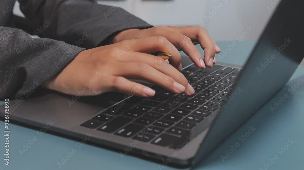 Hand of young female teacher or student typing on laptop keyboard while sitting by desk in front of camera and answering task questions Hand of young female teacher or student typing on laptop keyboard while sitting by desk in front of camera and answering task questions