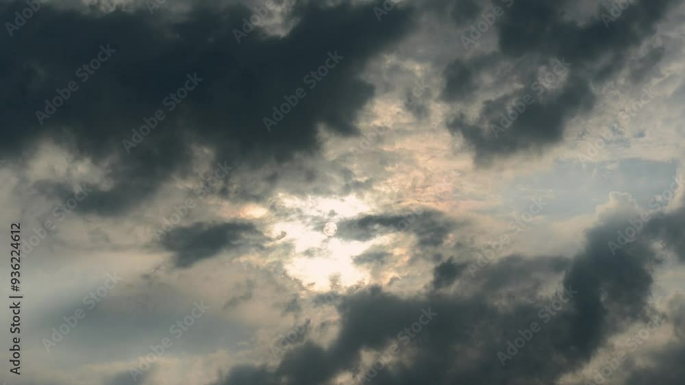A breathtaking celestial event captured as the sun partially emerges from behind a veil of clouds. The golden hues of the sun contrast beautifully with the dark, moody sky. DaJian Mountain, Taiwan. A breathtaking celestial event captured as the sun partially emerges from behind a veil of clouds. The golden hues of the sun contrast beautifully with the dark, moody sky. DaJian Mountain, Taiwan.