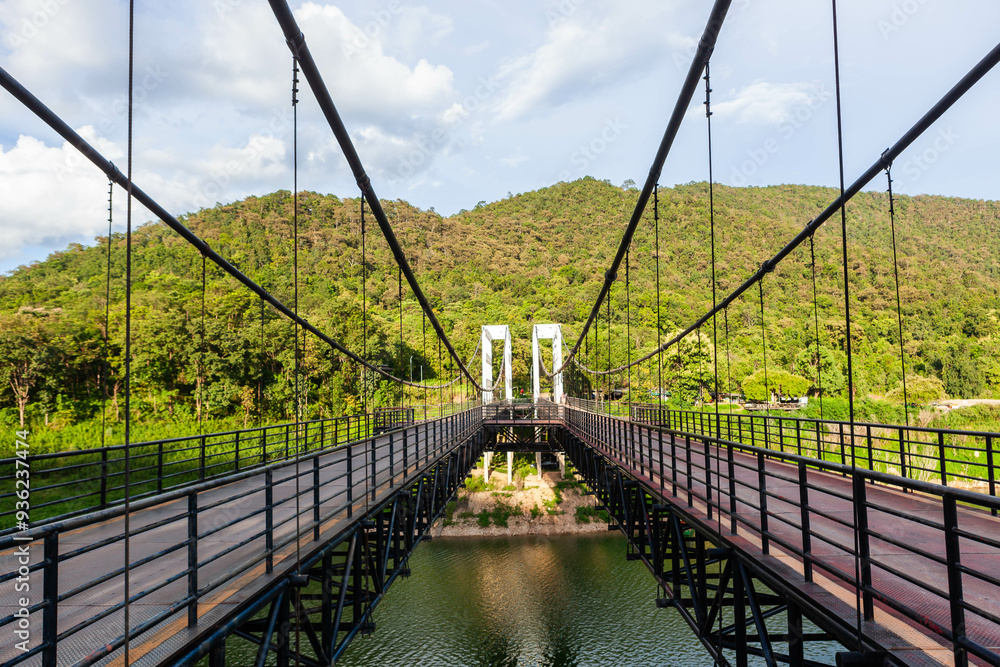 Mae Kuang Suspension Bridge through Mae Kuang reservoir in Chiang Mai province, North Thailand. Mae Kuang Suspension Bridge through Mae Kuang reservoir in Chiang Mai province, North Thailand.