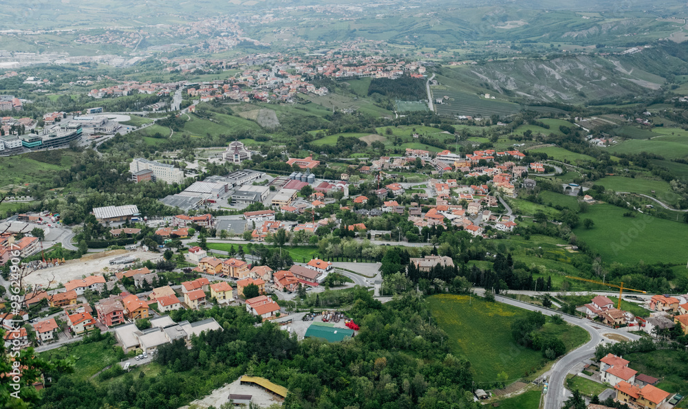 Aerial view of the picturesque landscape in San Marino showcasing lush greenery and charming architecture Aerial view of the picturesque landscape in San Marino showcasing lush greenery and charming architecture