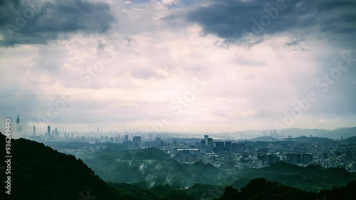 Stunning cityscapes can be seen beneath fast-moving dark clouds, the remnants of summer storms. Create visually striking compositions. Dajian Mountain. New Taipei City, Taiwan. photo