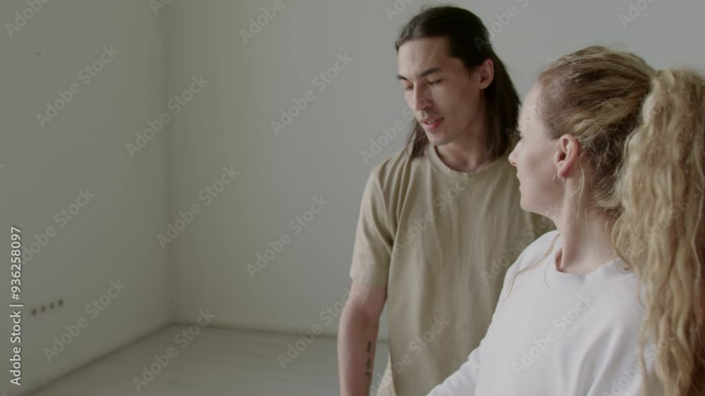 Professional ballerina teaching male partner how to perform arm movement during rehearsal in dance studio Professional ballerina teaching male partner how to perform arm movement during rehearsal in dance studio