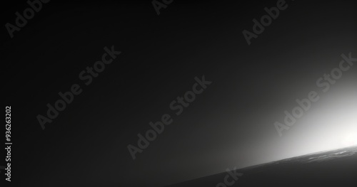 A minimalist image showcasing a gradient of light and shadow, suggesting a celestial or atmospheric scene.