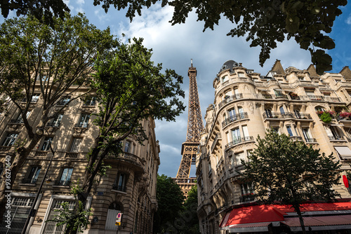 The Eiffel Tower framed by Parisian Architecture on Avenue de Suffren - Paris, France photo