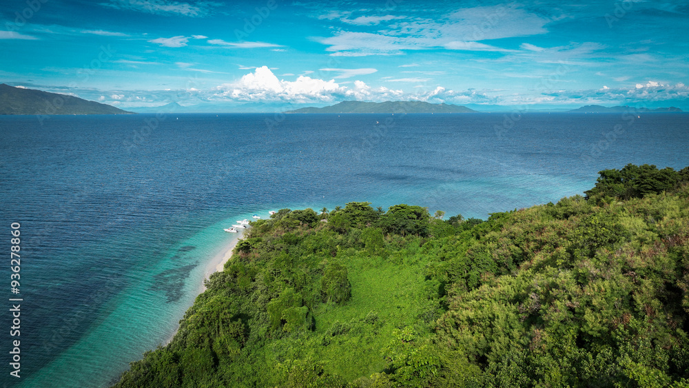 Aerial view of Nosy Tanikely island showcasing its lush greenery and vibrant blue waters in Madagascar Aerial view of Nosy Tanikely island showcasing its lush greenery and vibrant blue waters in Madagascar