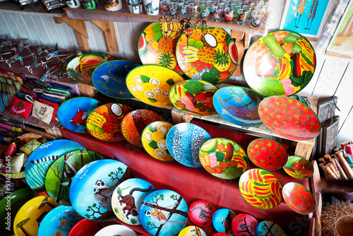 Colorful handmade souvenirs from Madagascar featuring vibrant designs and local artistry displayed in a market setting photo