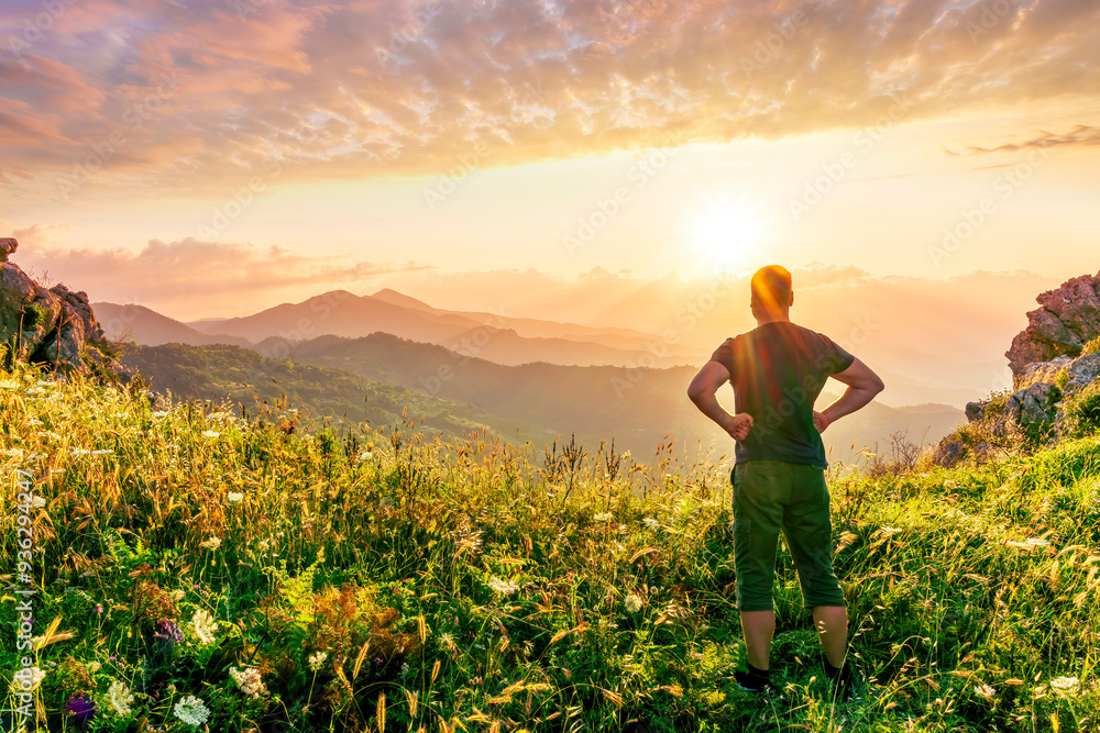 Fototapeta premium happy man watching amazing highland evening sunset, person delight with nature landscape