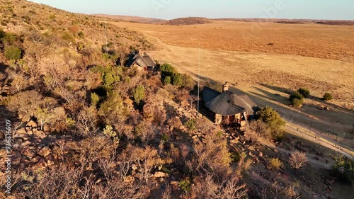 South African Safari Lodge at sunrise, showcasing breathtaking views of the open savannah, serene retreat, and exclusive adventure - in the Waterberg, Welgevonden Game Reserve, Limpopo, South Africa photo