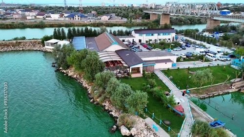 Aerial view rotating around a property by Tasaul Lake where people enjoy eating fish photo