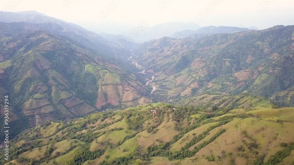 Aerial photograph showcasing the lush mountains and winding rivers in the southwest of Antioquia, Colombia. Captures the natural beauty and serene landscape of this picturesque region. Aerial photograph showcasing the lush mountains and winding rivers in the southwest of Antioquia, Colombia. Captures the natural beauty and serene landscape of this picturesque region.