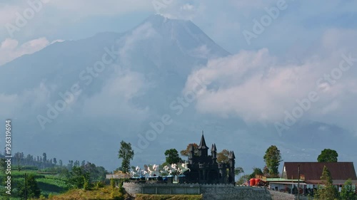 Iconic castle of Negeri Kahyangan in Indonesia with mountains in background, aerial view photo