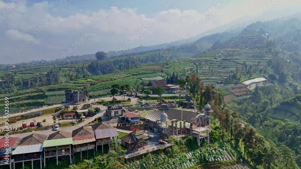 Aerial view of nature park on the higland. Castel building and play ground. Negeri Kahyangan travel destination on the slope of Merbabu Mountain, Indonesia. 4K drone shot. Aerial view of nature park on the higland. Castel building and play ground. Negeri Kahyangan travel destination on the slope of Merbabu Mountain, Indonesia. 4K drone shot.