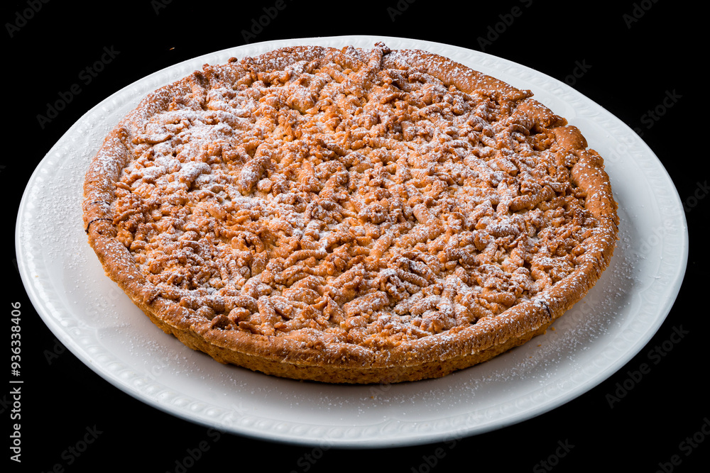 Crumbly pie with chocolate and powdered sugar in a plate. Crumbly pie with chocolate and powdered sugar in a plate.