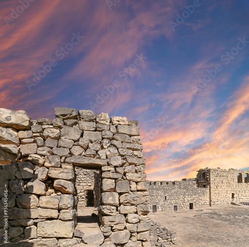 Ruins of Azraq Castle (Qasr al-Azraq) is a crusader castle (300AD),  central-eastern Jordan, 100 km east of Amman, Jordan. Against the background of a beautiful sky with clouds photo