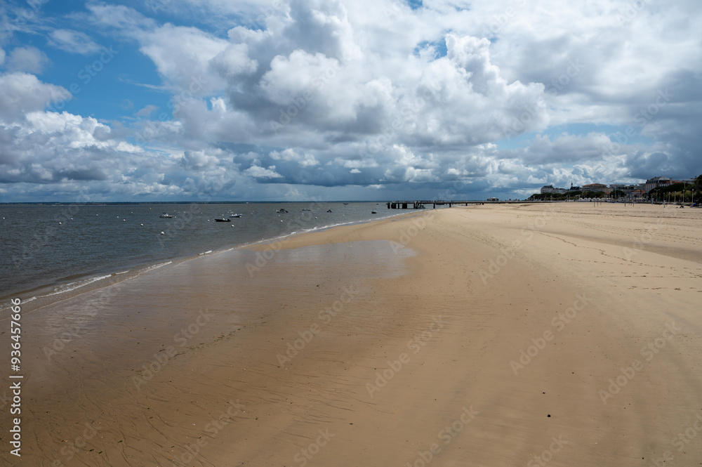 Walking on beach promenade in Arcachon, vacation destination town on Atlantic coast with beatiful parks, villas, streets and sandy beach, France Walking on beach promenade in Arcachon, vacation destination town on Atlantic coast with beatiful parks, villas, streets and sandy beach, France