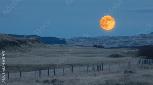 Full moon illuminating a tranquil landscape at dusk in a rural area