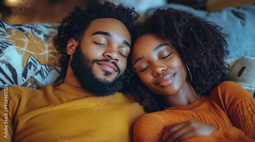 Cozy couple relaxing together on a couch in a warm, intimate setting during t...