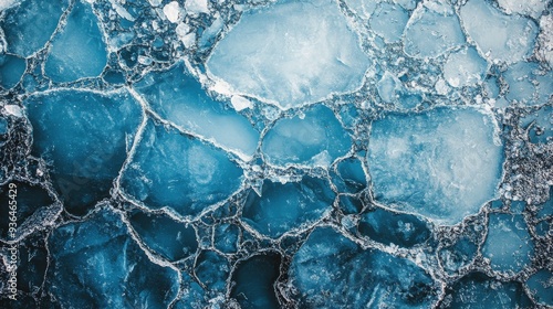 Cracked blue ice with clear water beneath at a frozen lake during winter