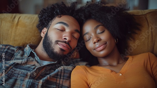 Cozy couple relaxing together on a couch in a warm, intimate setting during the evening