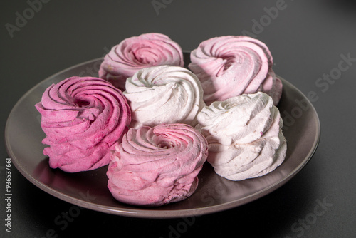 Sweet dessert zephyr. Marshmallows on a black background