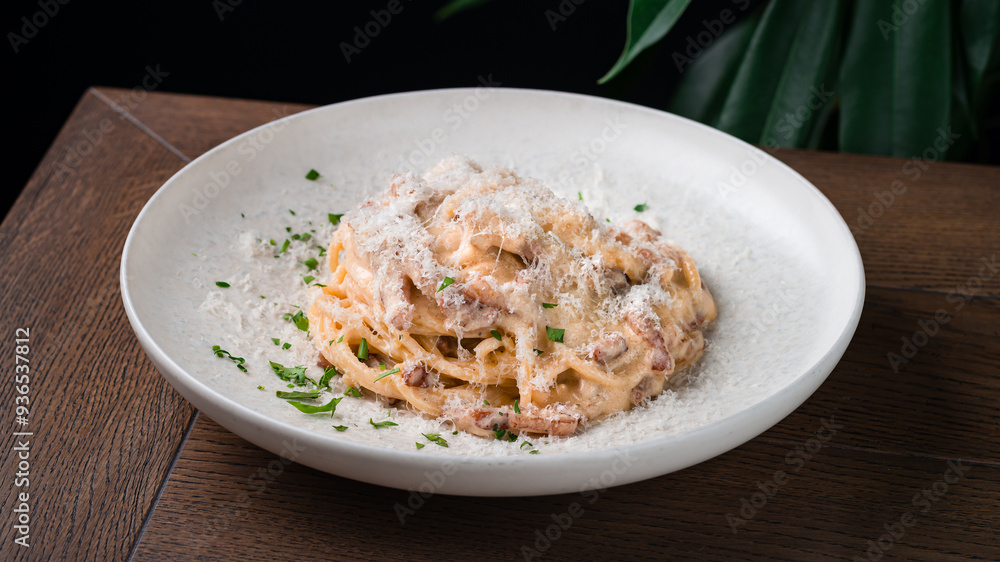Lunch pasta with bacon, parmesan cheese, cream sauce and greens. Lunch pasta with bacon, parmesan cheese, cream sauce and greens.