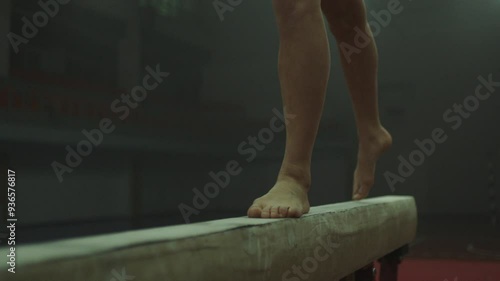 Legs of a Gymnast in red practicing on balance beam