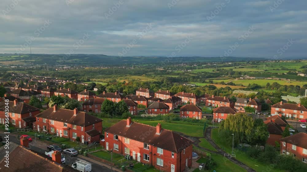Urban dwellings in Yorkshire: Aerial drone view of the red brick council estate, illuminated by the morning sun, with bustling streets. Urban dwellings in Yorkshire: Aerial drone view of the red brick council estate, illuminated by the morning sun, with bustling streets.