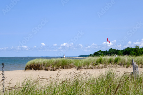 Sandy shores beach in the summer lighthouse at distance