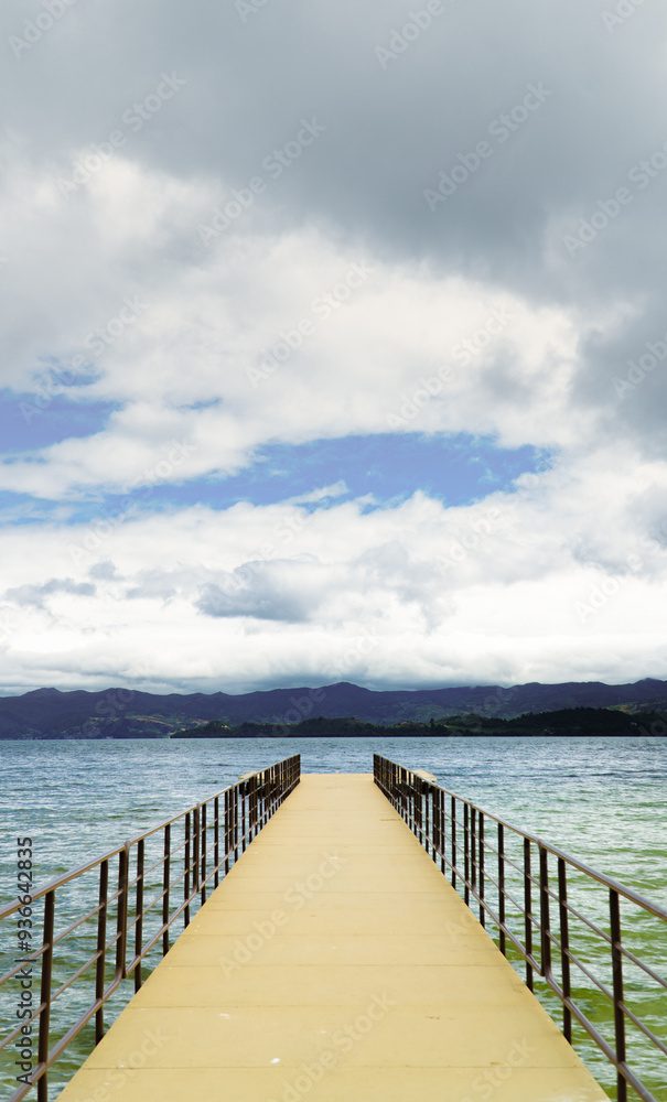 dock in the middle of the water with Andean mountains in the background dock in the middle of the water with Andean mountains in the background