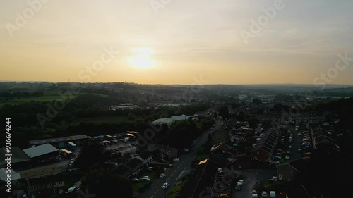 Heckmondwike, UK, captured by a drone, featuring industrial buildings, vibrant streets, the old town center, and the scenic Yorkshire view on a summer evening. photo