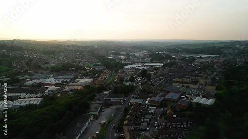 Wallpaper Mural Heckmondwike, UK, captured by a drone, featuring industrial buildings, vibrant streets, the old town center, and the scenic Yorkshire view on a summer evening. Torontodigital.ca