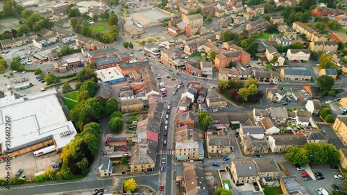 Heckmondwike, UK, captured by a drone, featuring industrial buildings, vibrant streets, the old town center, and the scenic Yorkshire view on a summer evening. photo