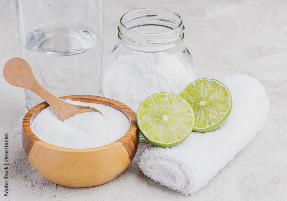 Baking soda and lime on a rustic surface Baking soda and lime on a rustic surface