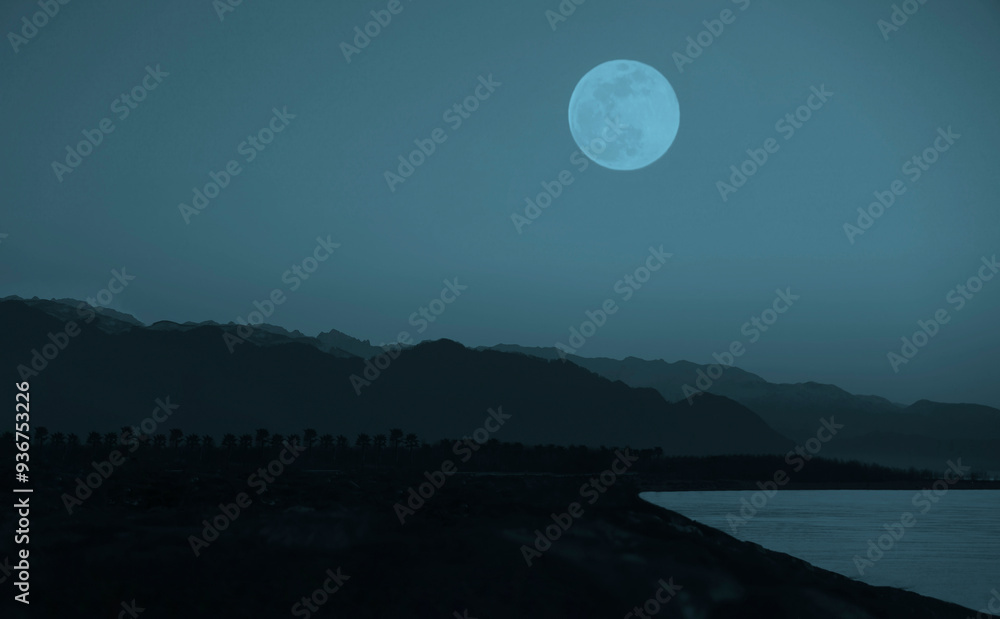 Fototapeta premium dusk on Black sea coast . Caucasian mountain. Batumi, Adjara, Georgia. beautiful sundown over rock. empty seacoast. no people. after sunset. full moon above peak. night scene. midnight. blue heaven.