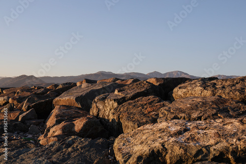 brown mountain range silhouettes. yellow panoramic landscape view. caucasian Mountain ridges and hills background. shade mount peaks. scenery terrain. Batumi Adjara Georgia. sunset light. evening time